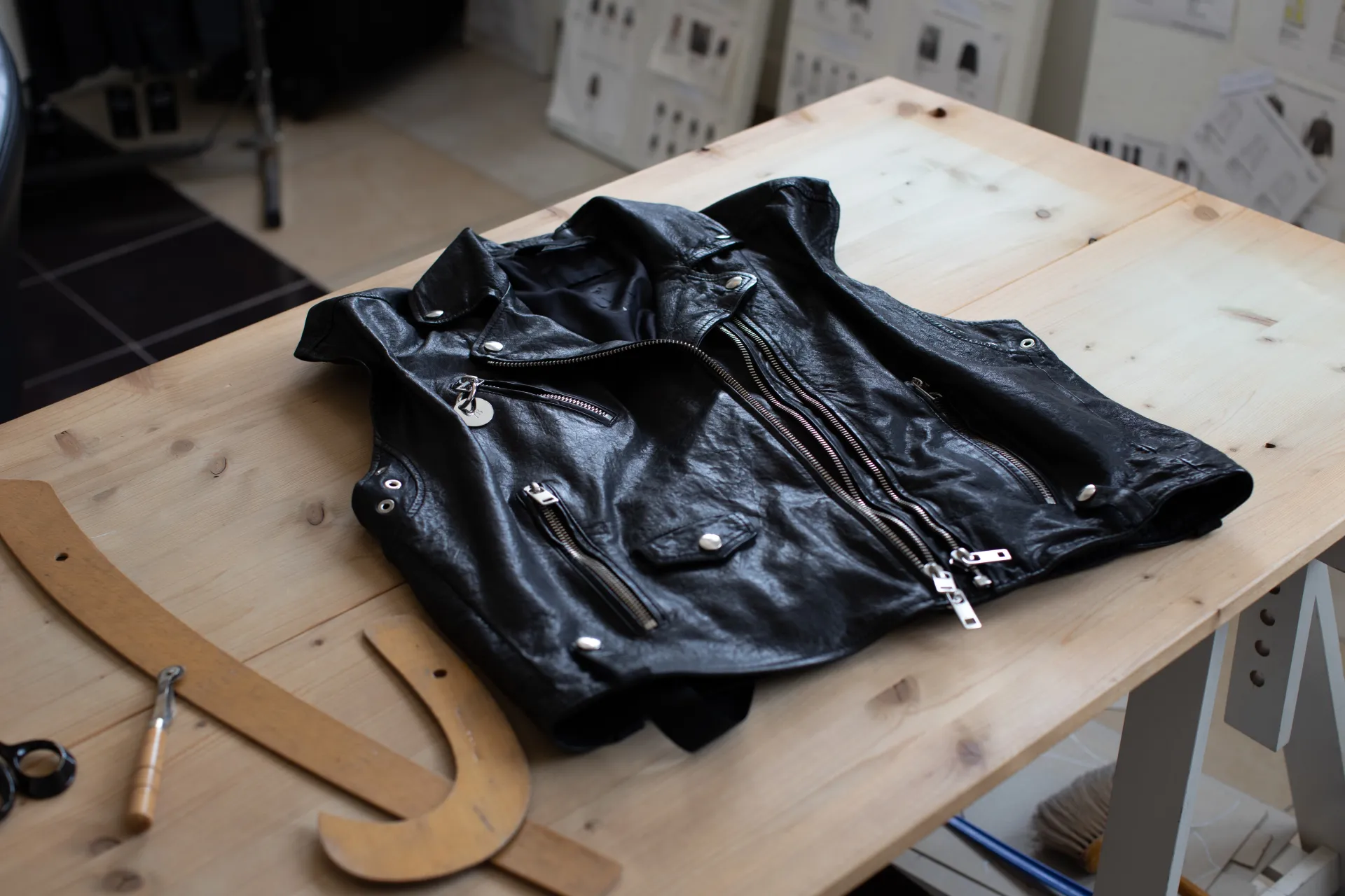 Hands guiding leather under a sewing machine needle